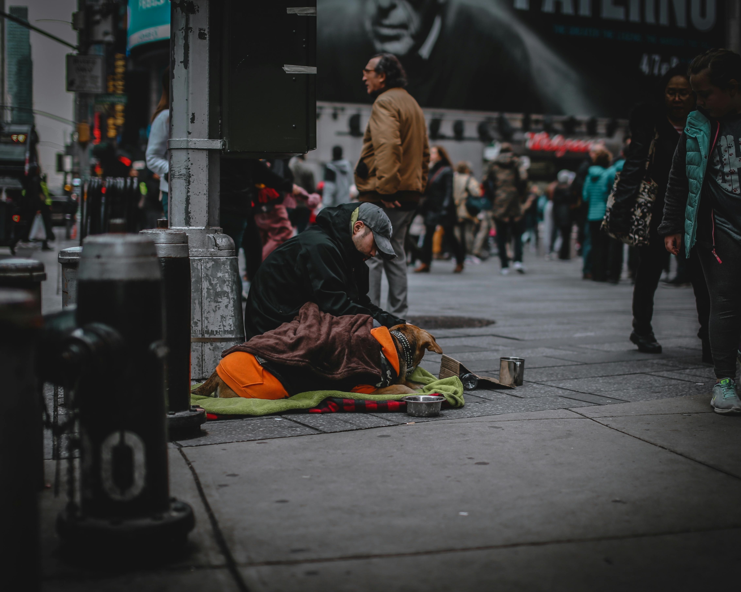 Man Siting on a Concrete Pavement